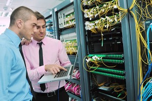 group of young business people it engineer in network server room solving problems and give help and support